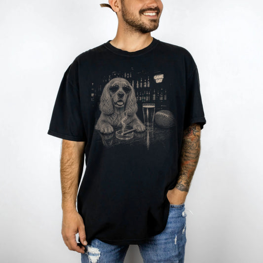 Model wearing a Black Comfort Colors® T-shirt featuring Cocker Spaniel with beer and football graphics
