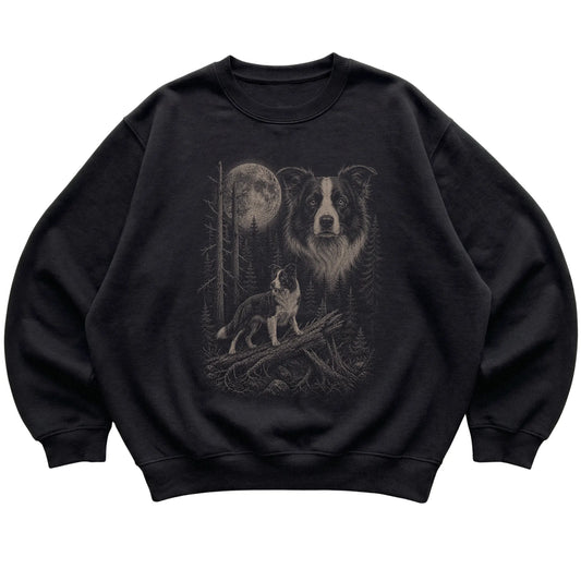 Border Collie Moonlit Forest graphic on a black crewneck sweatshirt laid flat