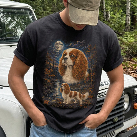 Model wearing a Black Comfort Colors® t-shirt featuring Cavalier King Charles Spaniel in a moonlit fall forest