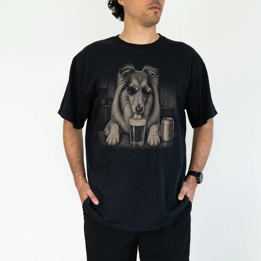 Model wearing a Black Comfort Colors® t-shirt with Collie sneaking a drink from a pint