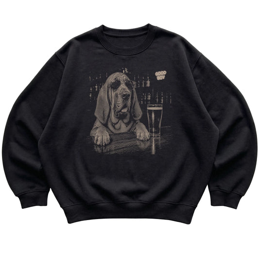 Black Bloodhound at a bar beside a pint, laid flat