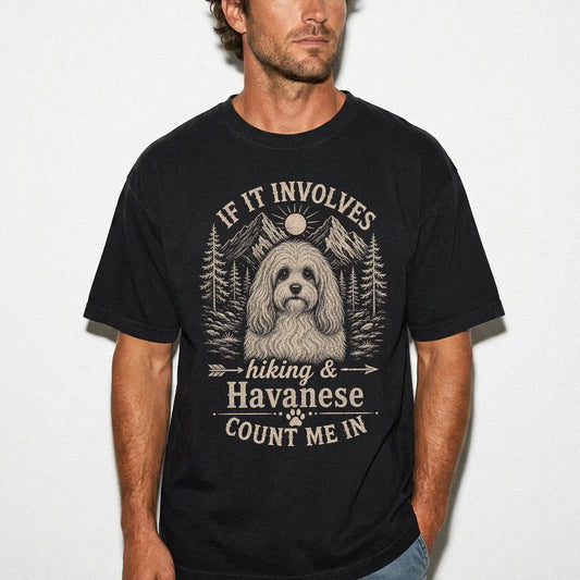 Model wearing a Black Comfort Colors® T-shirt featuring Havanese hiking design with mountain scenery