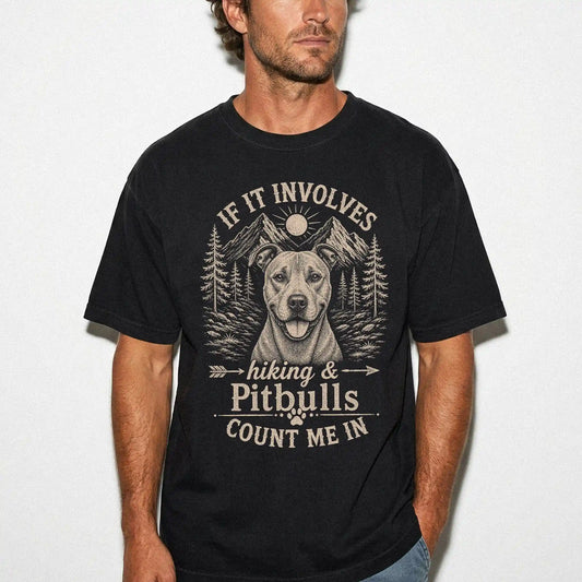 Model wearing a Black Comfort Colors® T-shirt featuring Pitbull hiking design with mountain scenery
