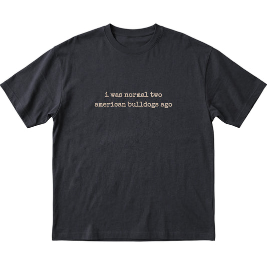 Black I Was Normal Two American Bulldogs Ago T-shirt laid flat