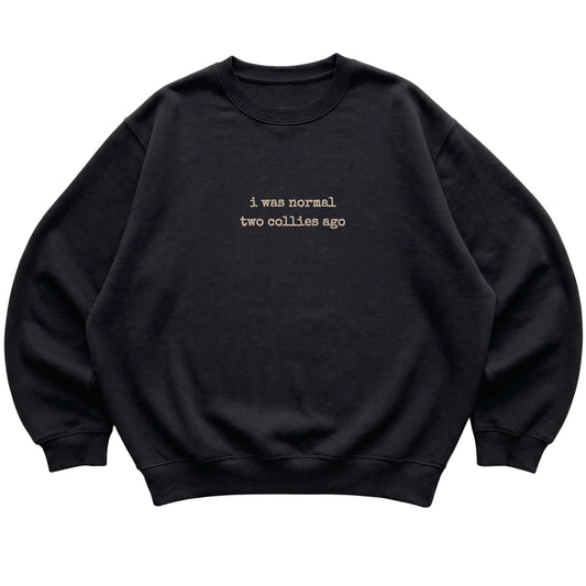 Black I Was Normal Two Collies Ago sweatshirt laid flat