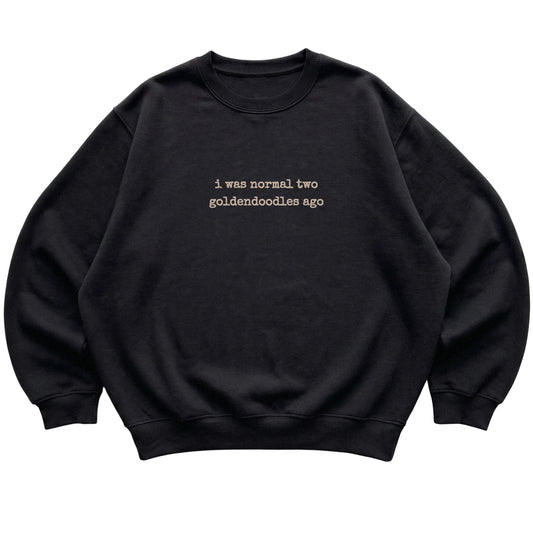 Black I Was Normal Two Goldendoodles Ago sweatshirt laid flat