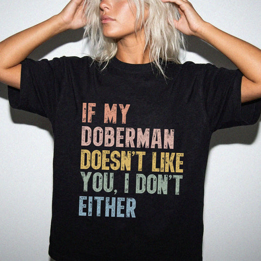 Model wearing a Black Comfort Colors® T-shirt featuring Doberman with “If My Dog Doesn’t Like You, I Don’t Either” lettering
