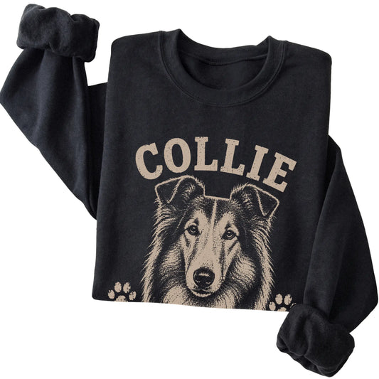 Black crewneck sweatshirt featuring Keeping Everyone In Line - Collie, folded presentation
