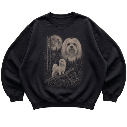 Maltese Moonlit Forest graphic on a black crewneck sweatshirt laid flat
