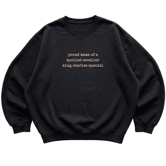 Black Proud Mama of a Spoiled Cavalier King Charles Spaniel sweatshirt laid flat