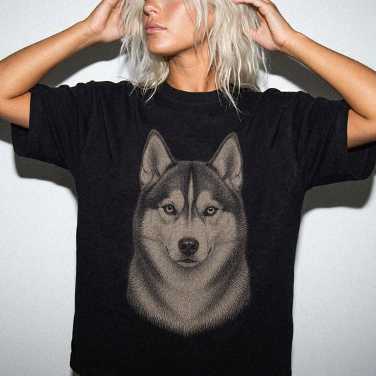 Model wearing a Black Comfort Colors® T-shirt with a realistic drawing of a Husky