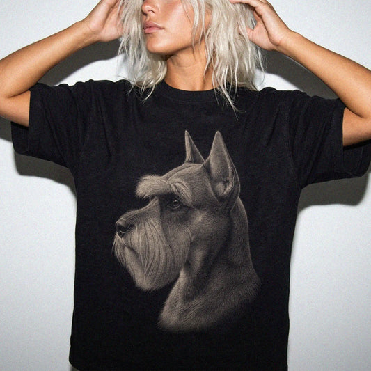 Model wearing a Black Comfort Colors® T-shirt with a detailed photographic portrait of a Schnauzer