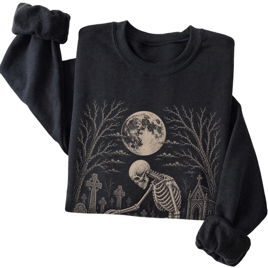 Folded Black sweatshirt with a skeleton petting a Beagle in a graveyard
