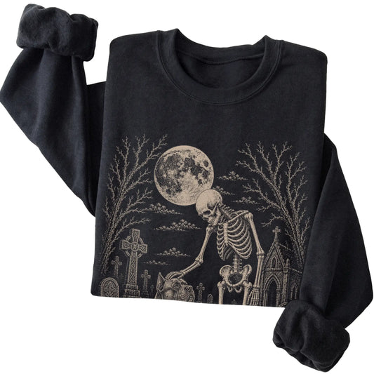 Folded Black sweatshirt with a skeleton petting a Cane Corso in a graveyard