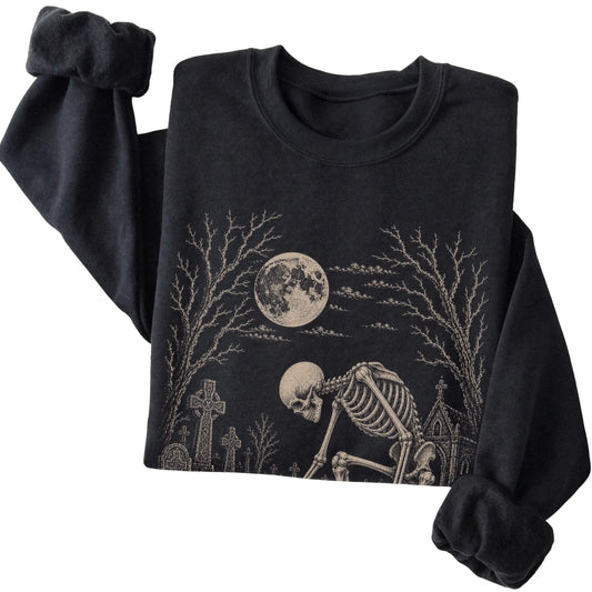 Folded Black sweatshirt with a skeleton petting a Dachshund in a graveyard