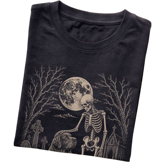 Folded Black T-shirt with a skeleton petting a Newfie in a graveyard