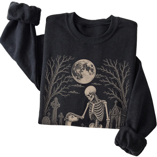 Folded Black sweatshirt with a skeleton petting a Whippet in a graveyard