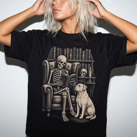 Model wearing a Black Comfort Colors® T-shirt showing skeleton reading in a library beside a American Bulldog