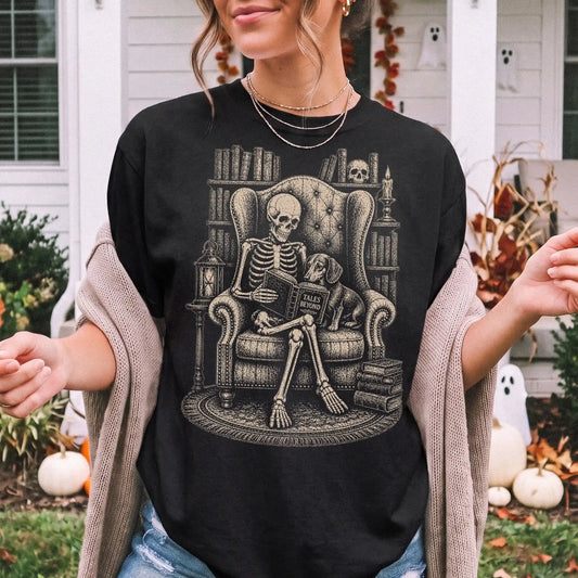 Model wearing a Black Comfort Colors® T-shirt showing skeleton reading in a library beside a Dachshund