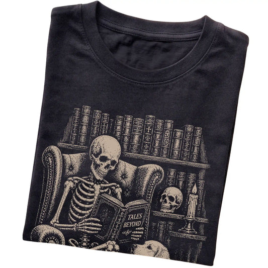 Folded Black T-shirt with a skeleton reading Tales Beyond to a Golden Retriever