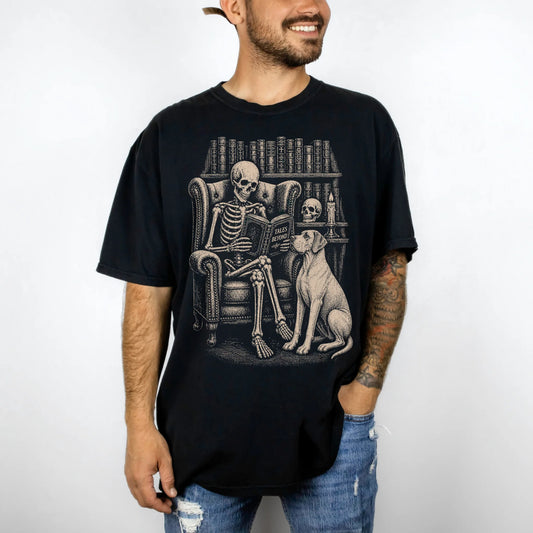 Model wearing a Black Comfort Colors® T-shirt showing skeleton reading in a library beside a Great Dane