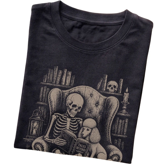 Folded Black T-shirt with a skeleton reading Tales Beyond to a Poodle