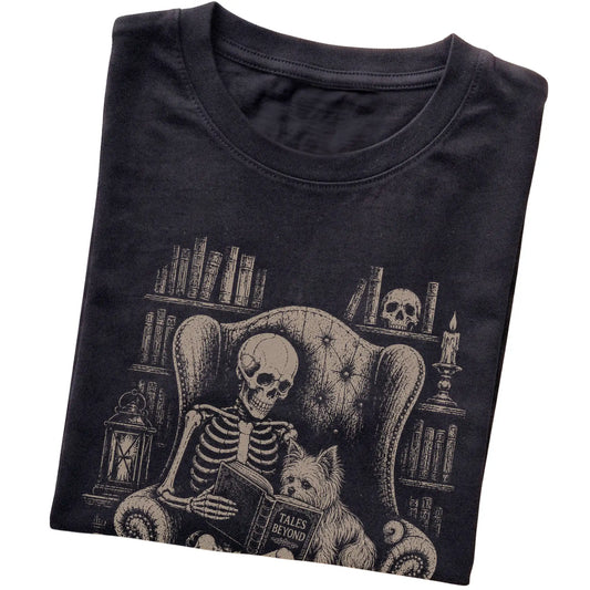 Folded Black T-shirt with a skeleton reading Tales Beyond to a Yorkie