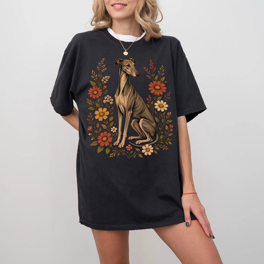 Model wearing a Black Comfort Colors® T-shirt showing Greyhound portrait surrounded by wildflowers beneath the moon