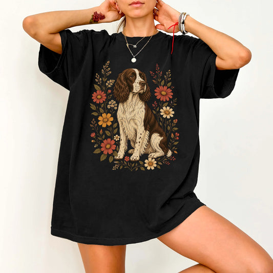 Model wearing a Black Comfort Colors® T-shirt showing Springer Spaniel portrait surrounded by wildflowers beneath the moon