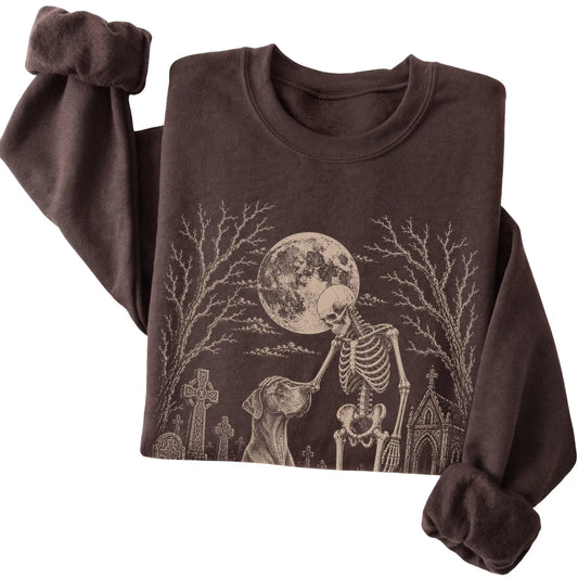 Folded Dark Chocolate sweatshirt with a skeleton petting a Great Dane in a graveyard