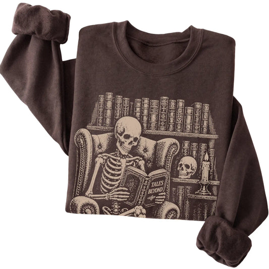 Folded Dark Chocolate sweatshirt with a skeleton reading Tales Beyond to a Basset Hound