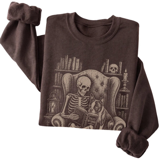 Folded Dark Chocolate sweatshirt with a skeleton reading Tales Beyond to a Boston Terrier