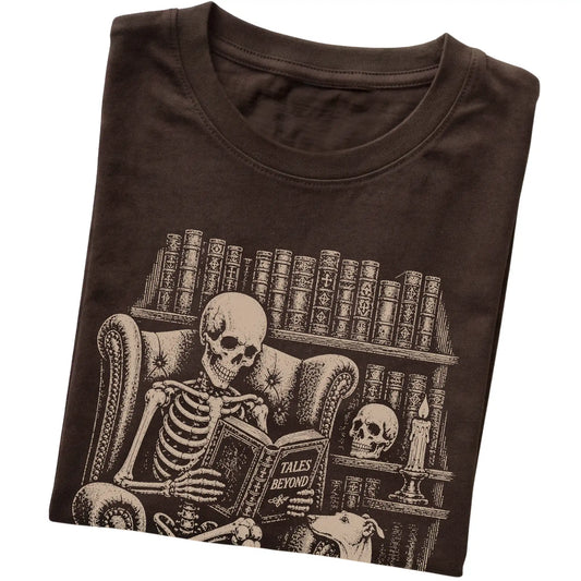 Folded Dark Chocolate T-shirt with a skeleton reading Tales Beyond to a Greyhound