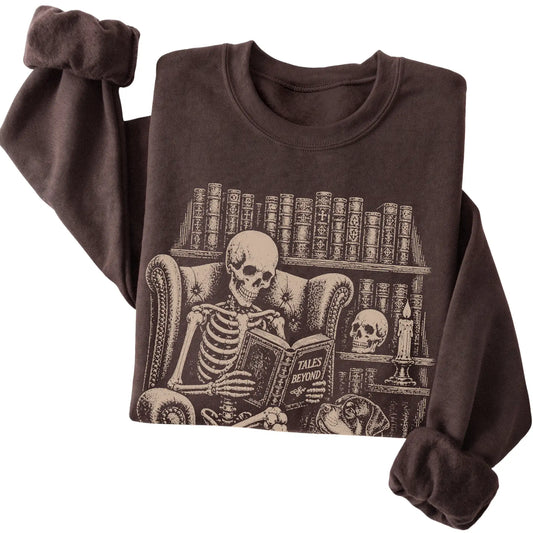 Folded Dark Chocolate sweatshirt with a skeleton reading Tales Beyond to a Rottweiler