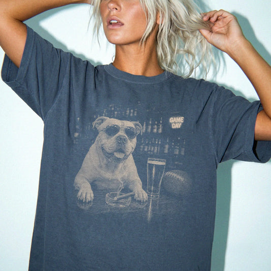 Model wearing a Denim Comfort Colors® T-shirt featuring American Bulldog with beer and football graphics