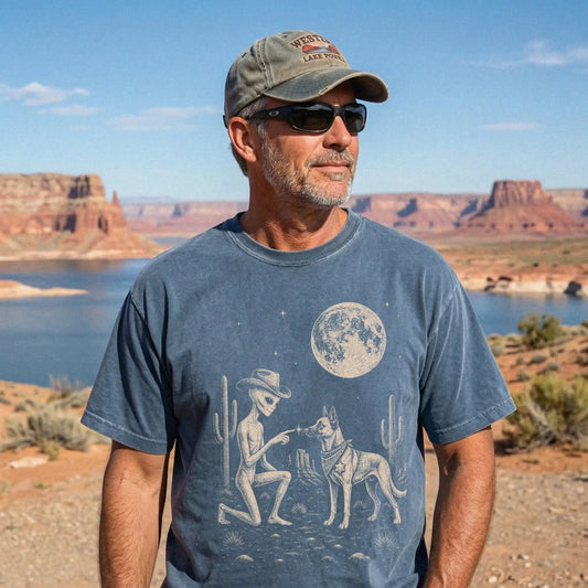 Model wearing a Denim Comfort Colors® T-shirt with cowboy alien fist-bumping a belgian malinois beneath the moon