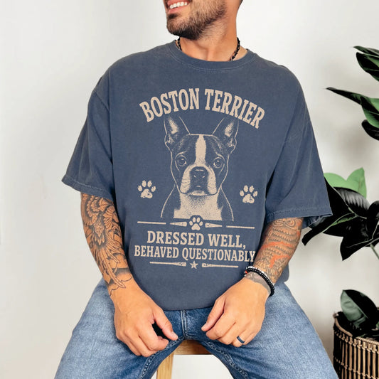 Model wearing a Denim Comfort Colors® T-shirt featuring Boston Terrier design with “Dressed Well, Behaved Questionably” lette
