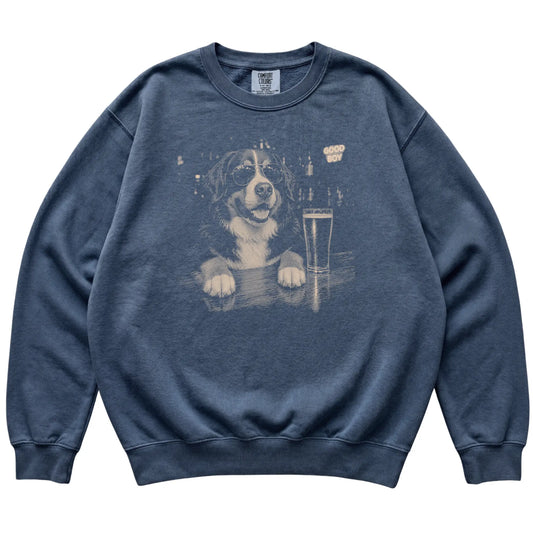 Denim Bernese Mountain Dog at a bar beside a pint, laid flat