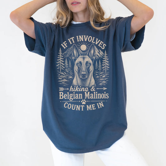Model wearing a Denim Comfort Colors® T-shirt featuring Belgian Malinois hiking design with mountain scenery