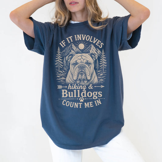 Model wearing a Denim Comfort Colors® T-shirt featuring Bulldog hiking design with mountain scenery