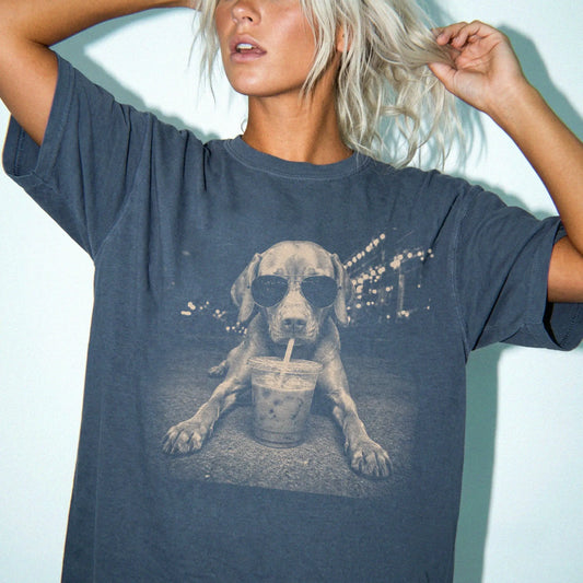 Model wearing a Denim Comfort Colors® T-shirt featuring Vizsla with iced coffee in a retro grunge design