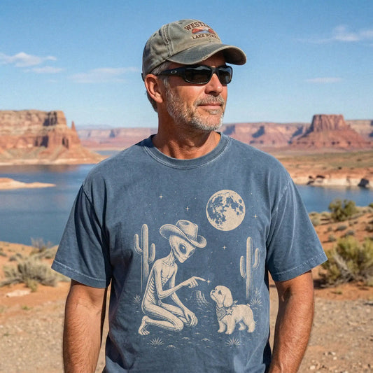 Model wearing a Denim Comfort Colors® T-shirt with cowboy alien fist-bumping a maltese beneath the moon