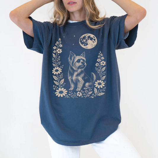 Model wearing a Denim Comfort Colors® T-shirt featuring Yorkie framed by flowers beneath the moon