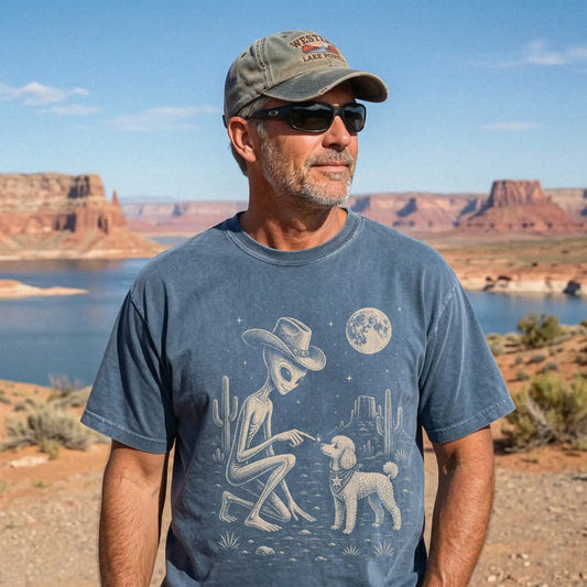 Model wearing a Denim Comfort Colors® T-shirt with cowboy alien fist-bumping a poodle beneath the moon