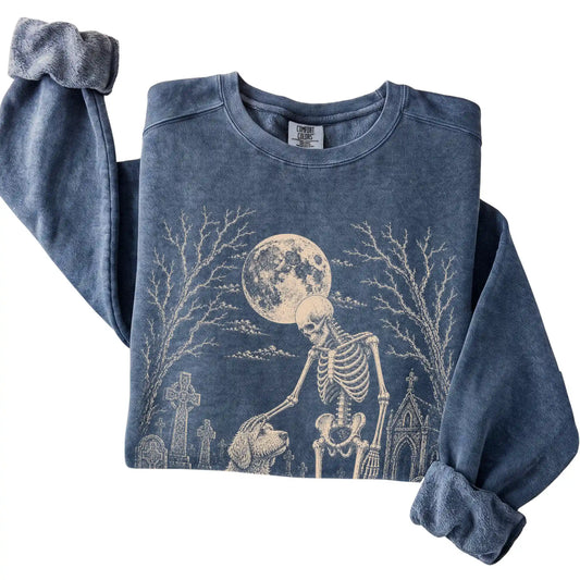 Folded Denim sweatshirt with a skeleton petting a Goldendoodle in a graveyard