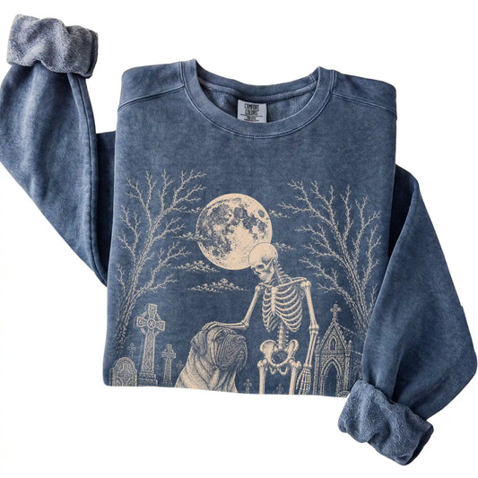 Folded Denim sweatshirt with a skeleton petting a Mastiff in a graveyard