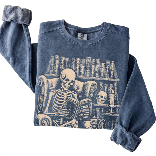 Folded Denim sweatshirt with a skeleton reading Tales Beyond to a Border Collie