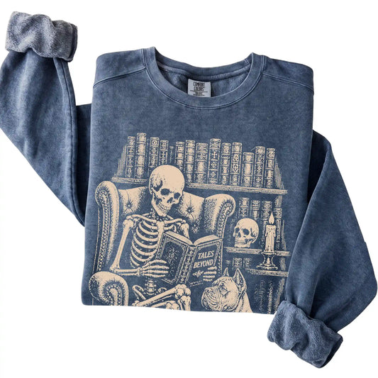 Folded Denim sweatshirt with a skeleton reading Tales Beyond to a Cane Corso