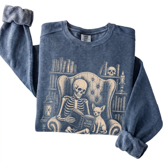 Folded Denim sweatshirt with a skeleton reading Tales Beyond to a Chihuahua