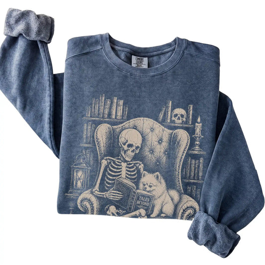 Folded Denim sweatshirt with a skeleton reading Tales Beyond to a Pomeranian